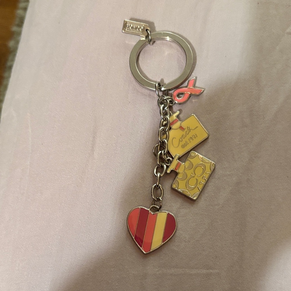Never used. Still in bag. Colorful Coach Heart and Charm Keychain.